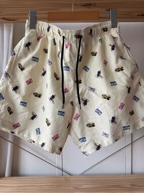 Pale yellow swim trunks with Retro Music Print